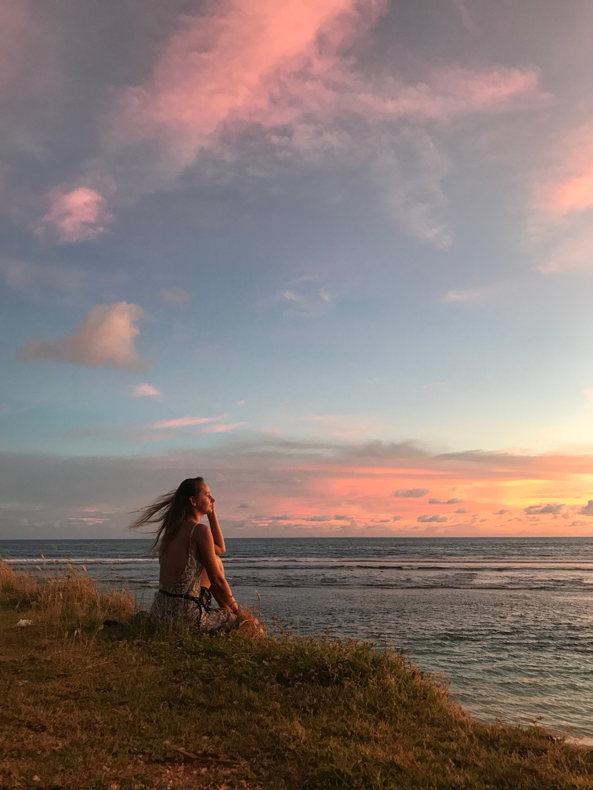 A Woman Sitting and Looking at the Ocean